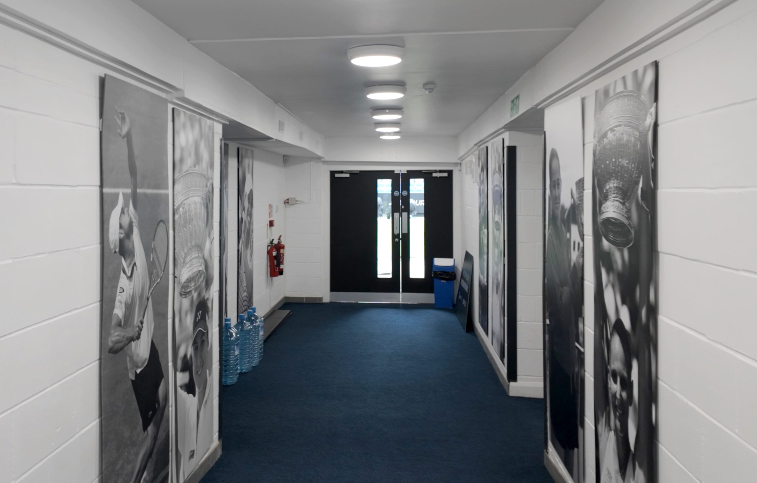 Hallway at Devonshire Park featuring large black and white tennis photography prints installed by Beautiful LFP for the Eastbourne Tennis Tournament.