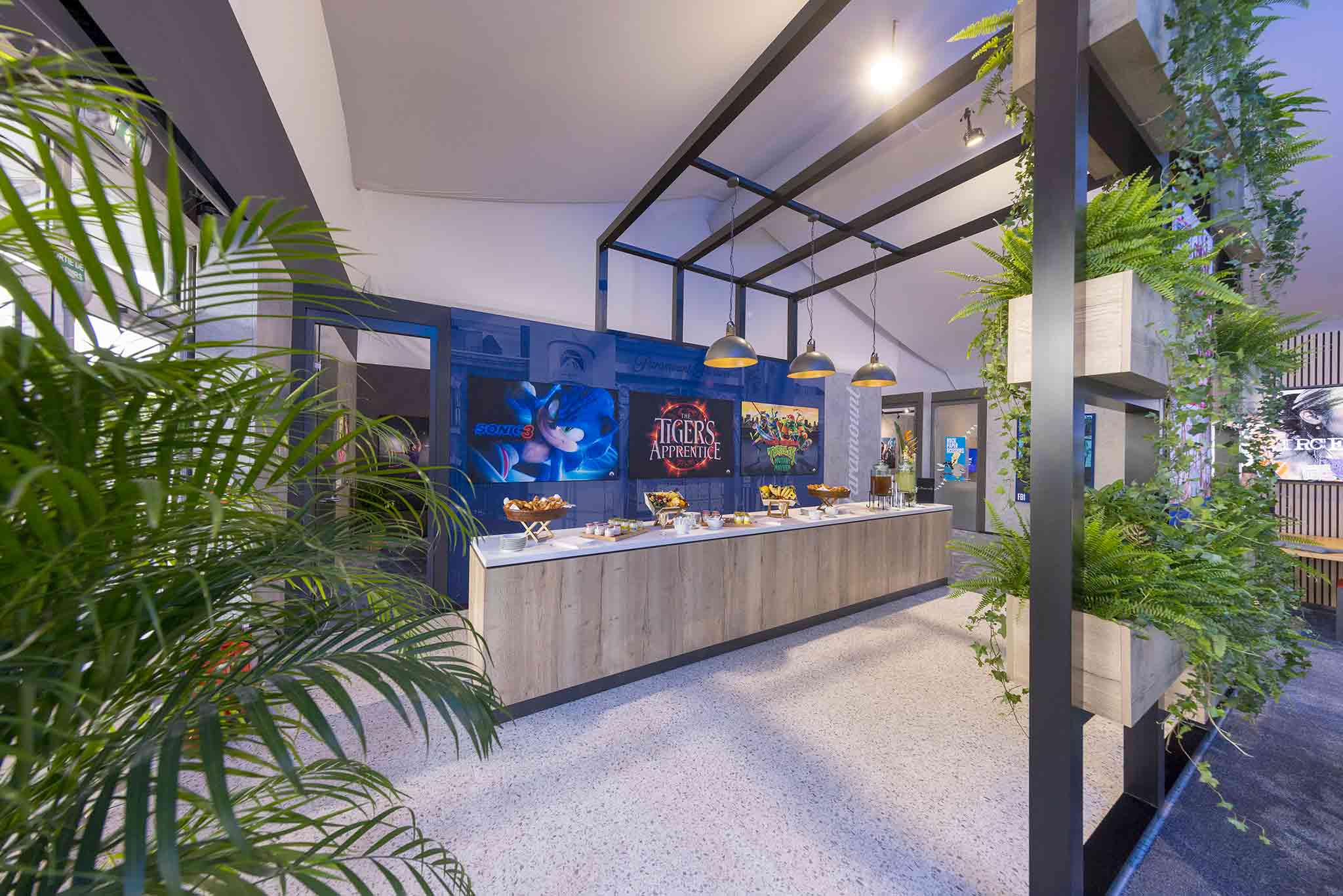 Paramount exhibition stand with custom-built breakfast bar and branded interior graphics by Beautiful LFP