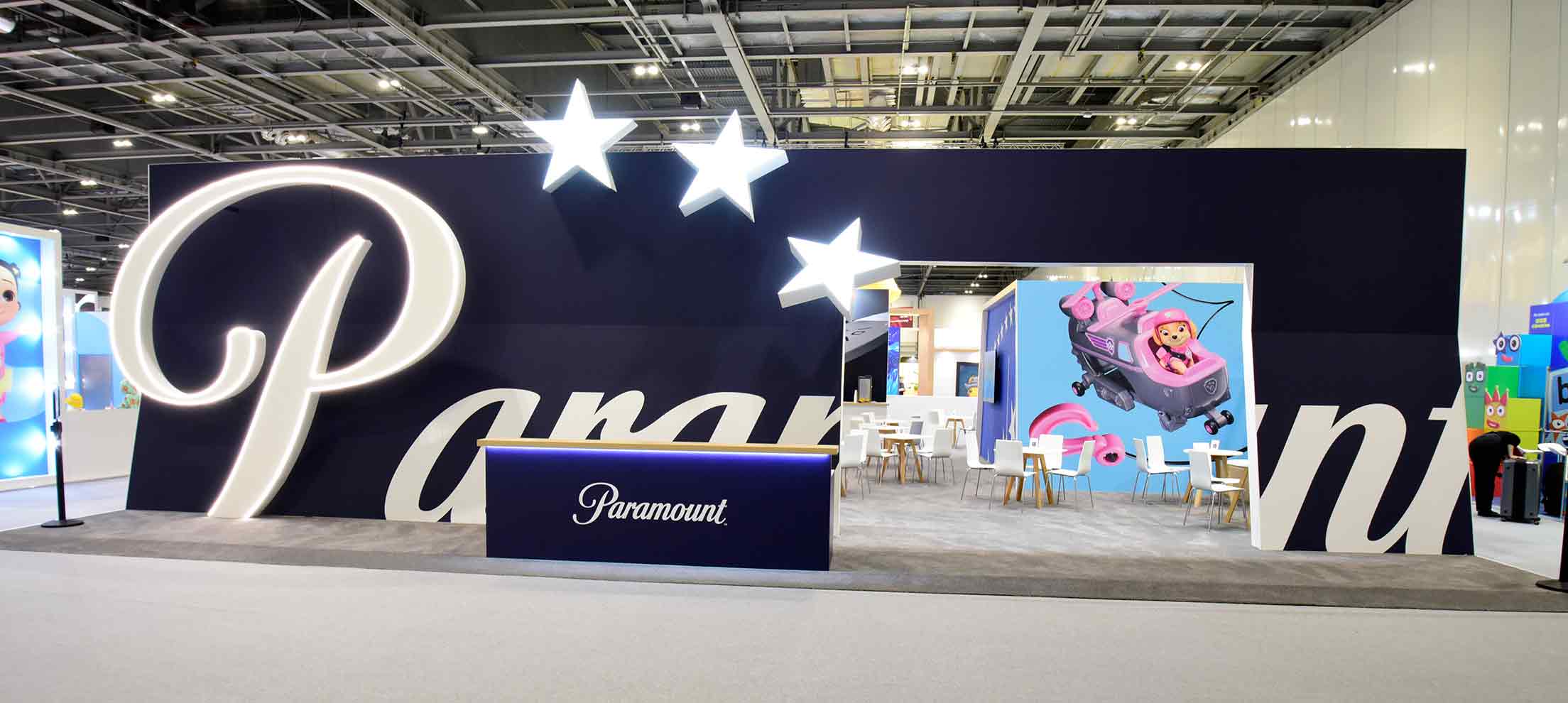 Paramount exhibition stand with illuminated logo, star feature lighting, and branded display area by Beautiful LFP