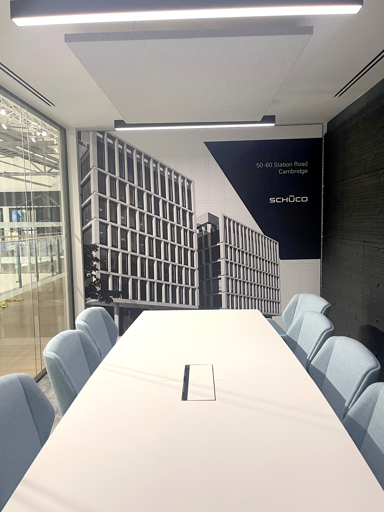 Schüco UK meeting room interior branding installation in Milton Keynes featuring large format wall mural and corporate graphics